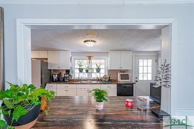 kitchen with sink, tasteful backsplash, stainless steel fridge, dishwasher, and white cabinets