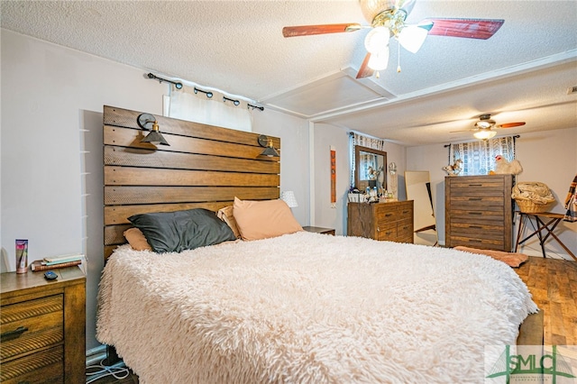 bedroom featuring hardwood / wood-style flooring and a textured ceiling