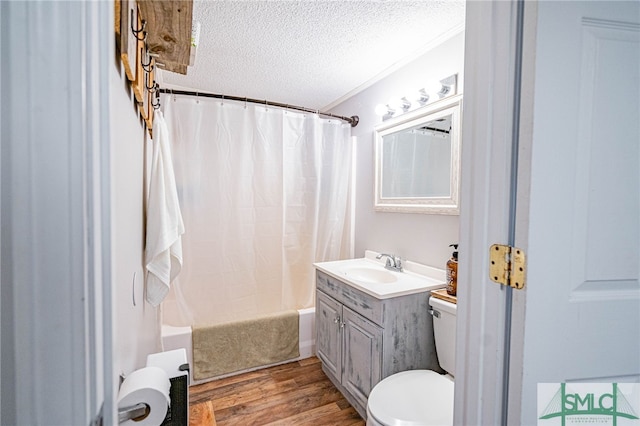 full bathroom featuring shower / bath combo, vanity, wood-type flooring, a textured ceiling, and toilet