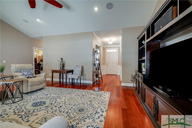 living room with ceiling fan, ornamental molding, and dark hardwood / wood-style floors