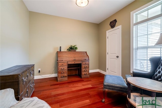 living area with dark wood-style flooring and baseboards