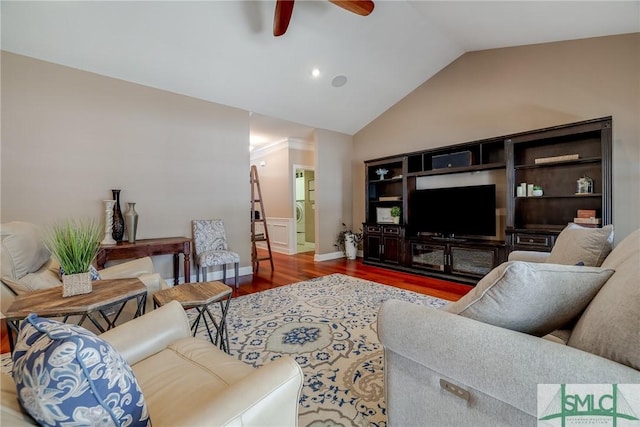 living area with baseboards, a ceiling fan, vaulted ceiling, and wood finished floors