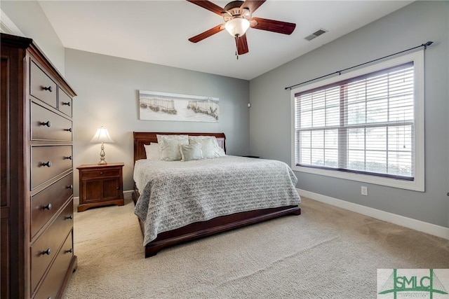 bedroom featuring light carpet, baseboards, visible vents, and ceiling fan