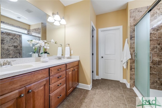 bathroom with an enclosed shower, vanity, and tile patterned flooring