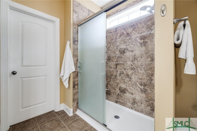 bathroom featuring a shower with door and tile patterned floors