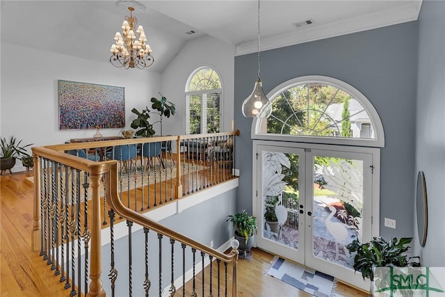 interior space featuring hardwood / wood-style flooring, vaulted ceiling, a chandelier, and french doors