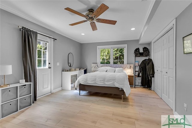 bedroom featuring multiple windows, crown molding, and light hardwood / wood-style flooring