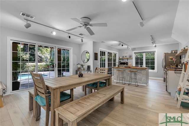 dining area featuring ceiling fan, track lighting, and light wood-type flooring