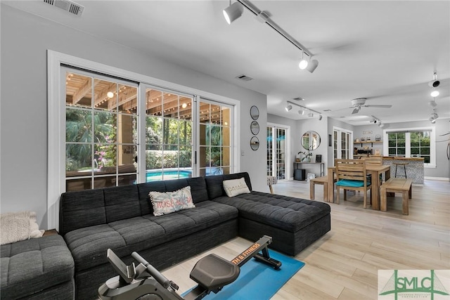 living room featuring ceiling fan, track lighting, and light wood-type flooring