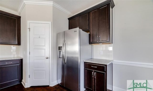 kitchen featuring dark brown cabinetry, stainless steel fridge with ice dispenser, ornamental molding, light stone countertops, and backsplash