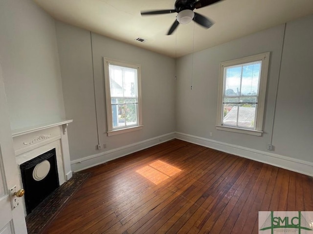 unfurnished living room with dark wood-type flooring and ceiling fan