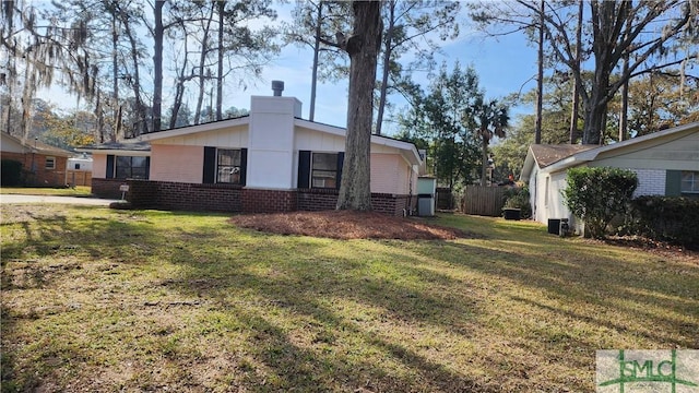 view of side of home featuring a lawn