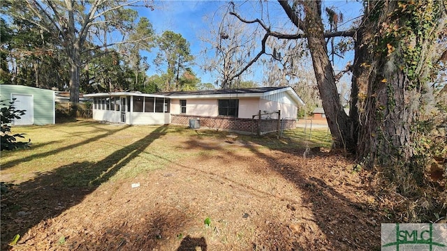 exterior space featuring a sunroom and a front yard