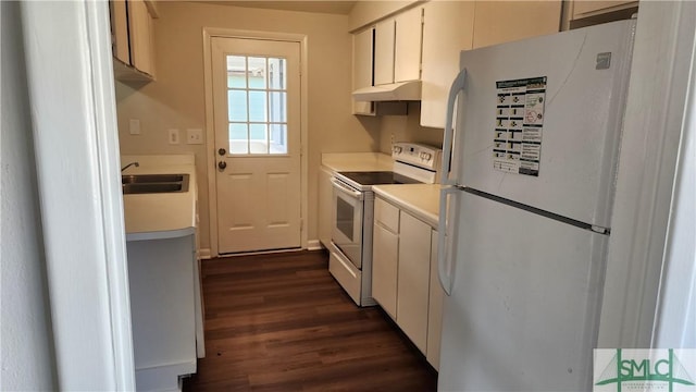 kitchen with sink, dark wood-type flooring, white cabinets, and white appliances