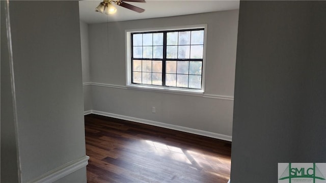 empty room with dark hardwood / wood-style flooring and ceiling fan