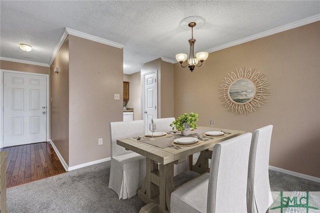 carpeted dining area featuring an inviting chandelier, ornamental molding, and a textured ceiling