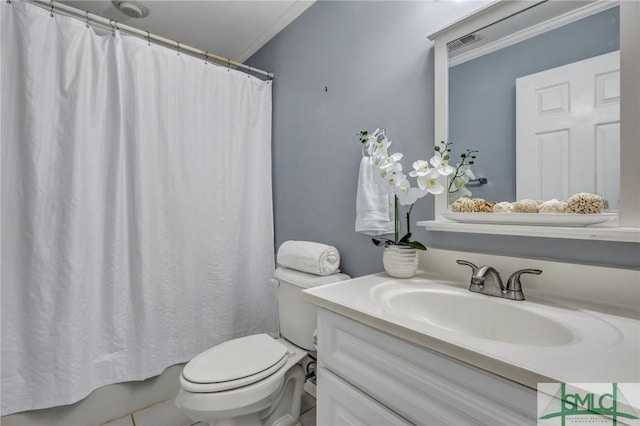 bathroom with vanity, crown molding, and toilet