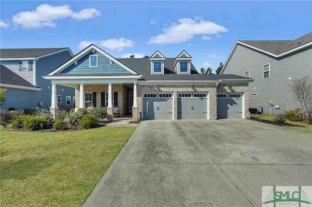 craftsman-style home with a garage, covered porch, and a front yard