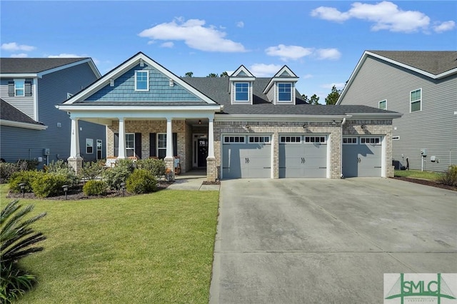 craftsman-style home with a garage, a front lawn, and covered porch