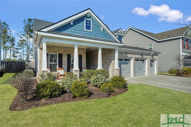 craftsman-style home featuring a garage, a porch, and a front yard