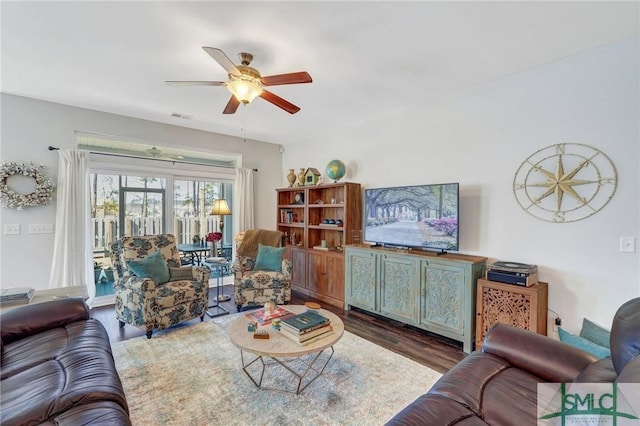 living room with dark hardwood / wood-style floors and ceiling fan