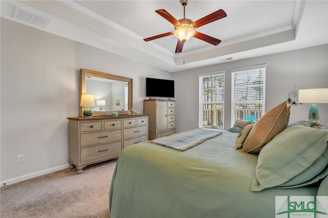 carpeted bedroom featuring crown molding, ceiling fan, and a tray ceiling