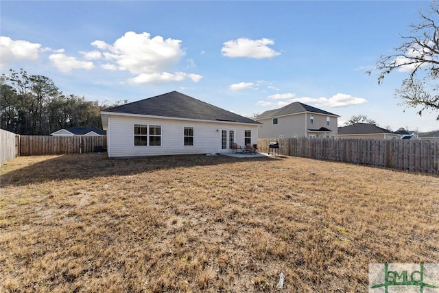 back of house with a yard and a patio area