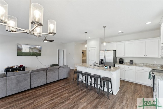 kitchen featuring appliances with stainless steel finishes, sink, an island with sink, and white cabinets