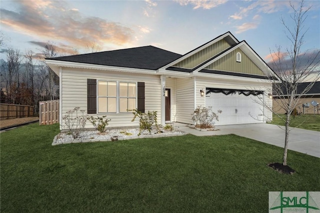 view of front of home with a garage and a yard