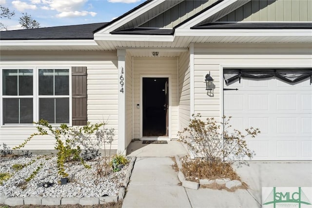 view of exterior entry with a garage