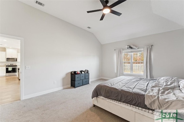 carpeted bedroom featuring ceiling fan and vaulted ceiling