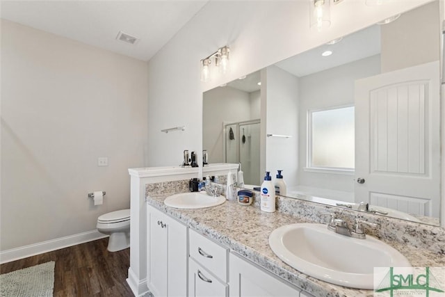 full bathroom featuring plus walk in shower, hardwood / wood-style floors, vanity, and toilet