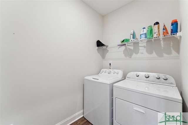 clothes washing area with independent washer and dryer and dark hardwood / wood-style flooring