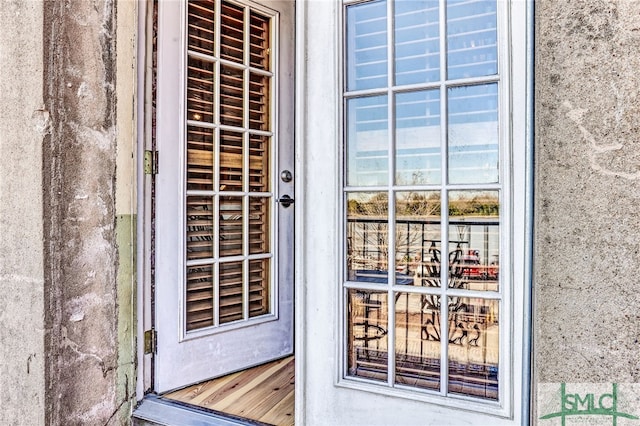 doorway to property featuring stucco siding