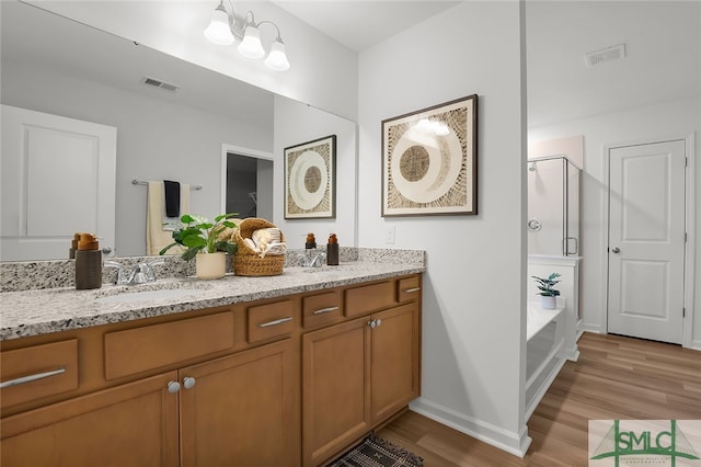 1001 Easthaven Blvd, Pooler, GA 31322 - full bathroom featuring a stall shower, wood finished floors, double vanity, baseboards, and a garden tub
