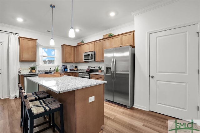 1001 Easthaven Blvd, Pooler, GA 31322 - kitchen featuring appliances with stainless steel finishes, ornamental molding, a center island, a breakfast bar area, and decorative light fixtures