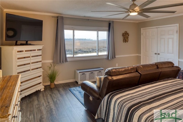 bedroom featuring dark hardwood / wood-style flooring, ornamental molding, and ceiling fan