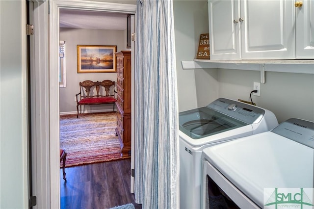 laundry area with cabinets, separate washer and dryer, and dark hardwood / wood-style floors