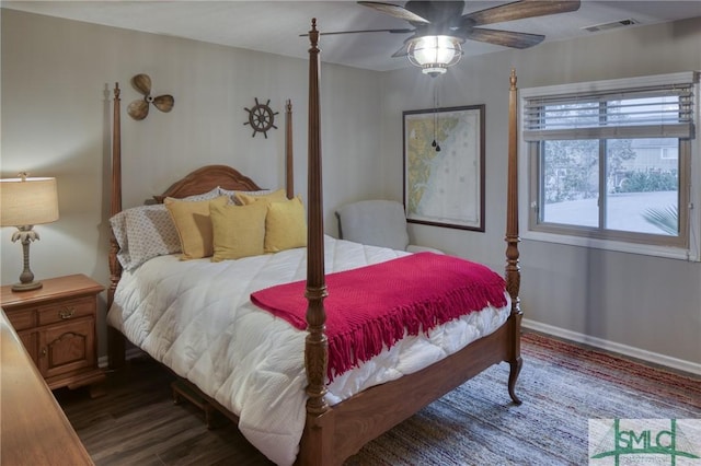 bedroom with ceiling fan and dark hardwood / wood-style flooring