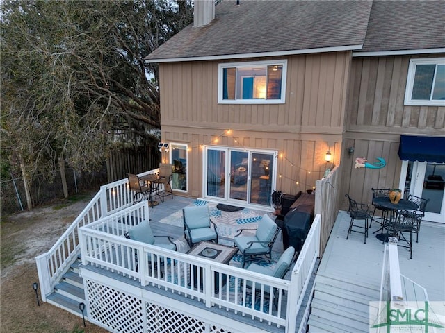 rear view of house with a wooden deck and an outdoor living space