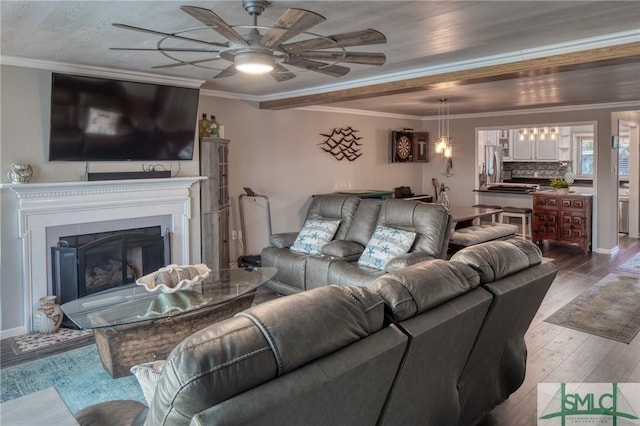 living room featuring ceiling fan, ornamental molding, and hardwood / wood-style floors