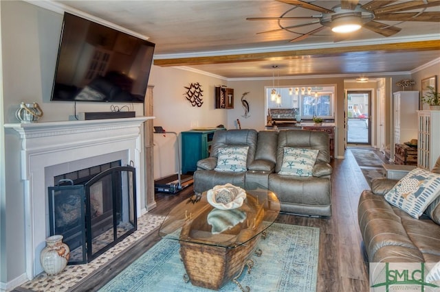 living room featuring crown molding, wood-type flooring, and ceiling fan