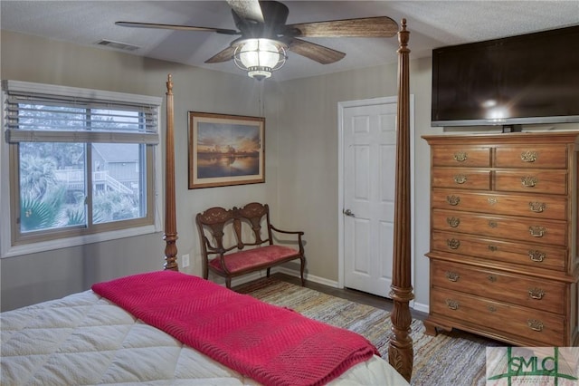 bedroom with wood-type flooring and ceiling fan