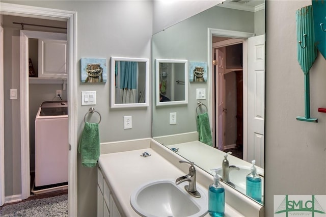 bathroom featuring vanity and washer / dryer