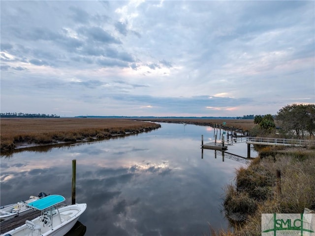 dock area with a rural view and a water view