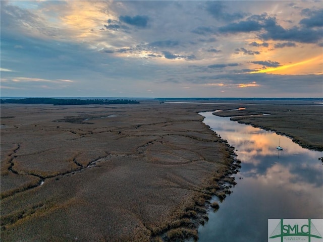 aerial view at dusk with a water view