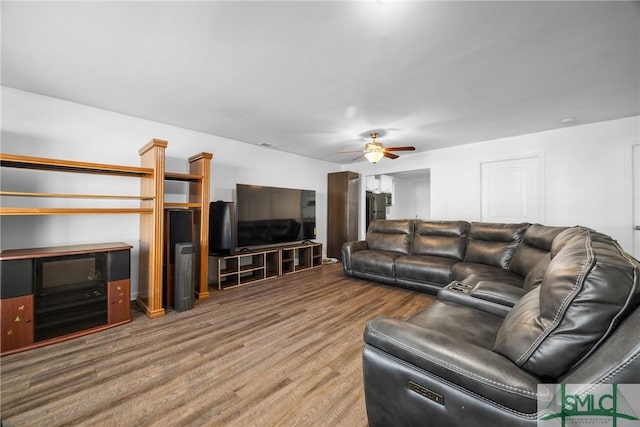 living room featuring hardwood / wood-style flooring and ceiling fan