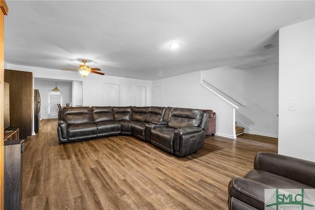 living room featuring hardwood / wood-style floors and ceiling fan