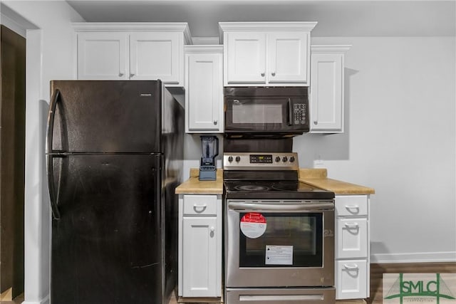 kitchen featuring hardwood / wood-style floors, white cabinets, and black appliances