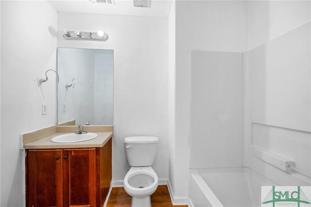 bathroom featuring vanity, toilet, and wood-type flooring